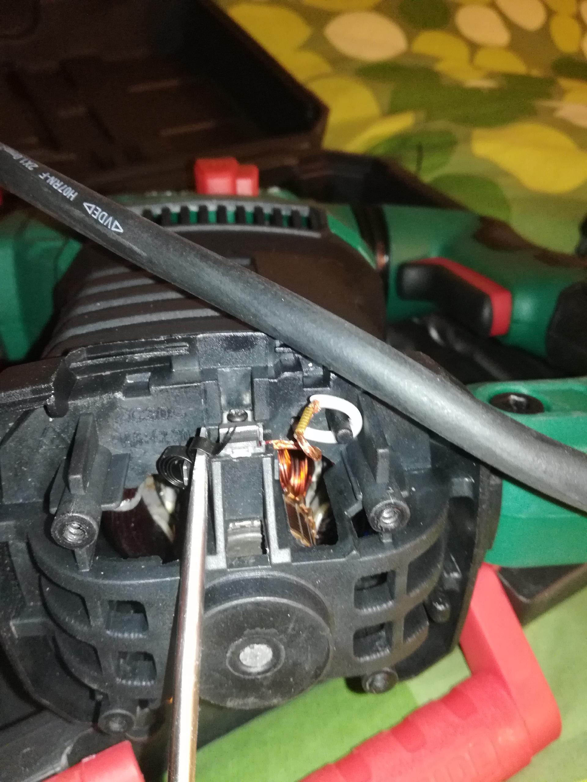 Block the spring using a flat screw driver